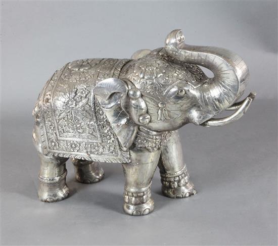 A large Indian white metal overlaid hardwood model of an elephant, length 33in. height 27in.